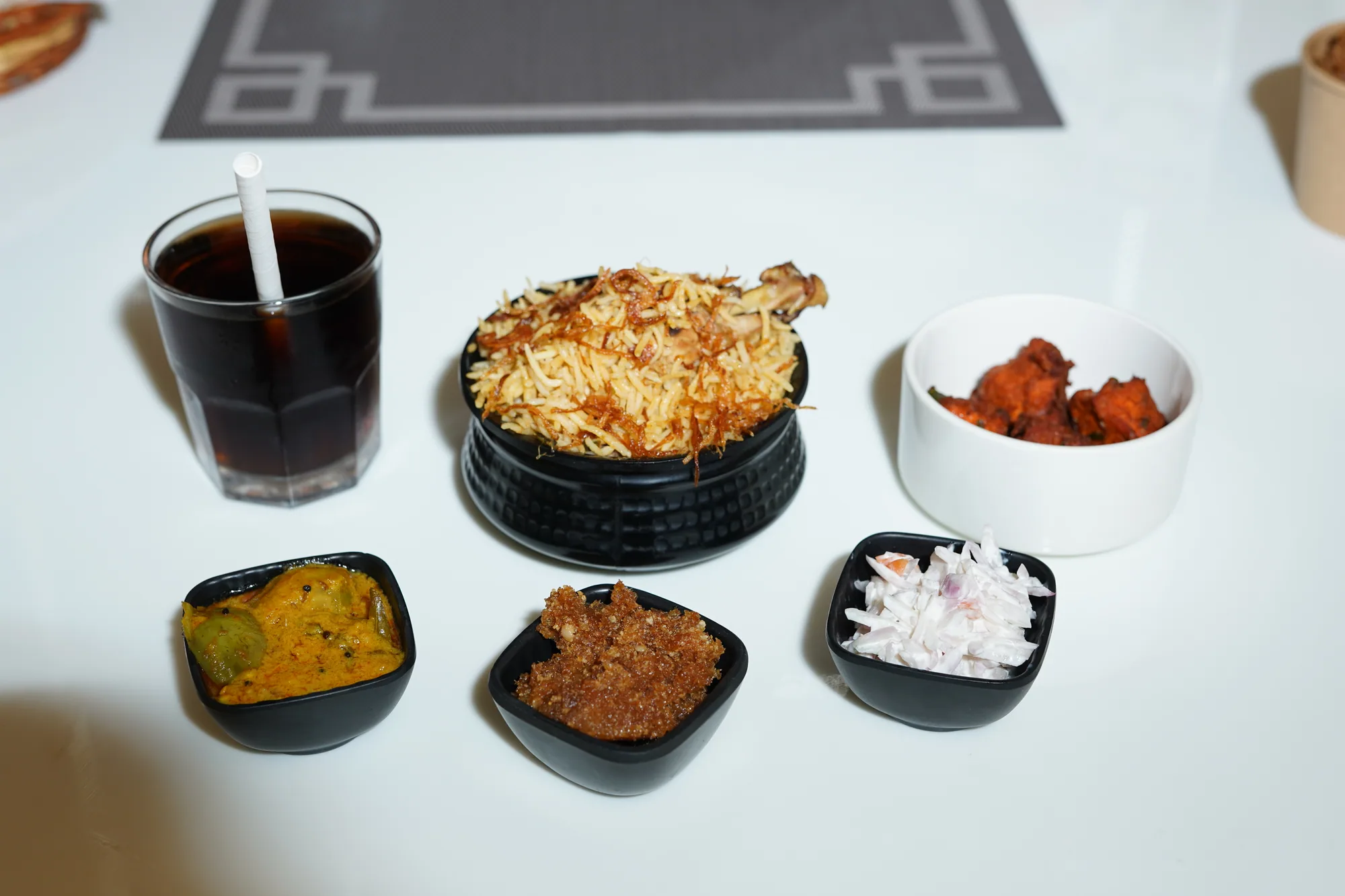 Zeeya Sulthans dum biryani served with egg, raita and accompaniments